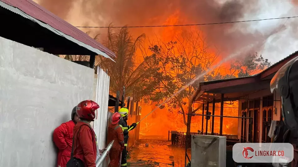 Petugas Damkar terus berupaya keras memadamkan api ditengah pemukiman padat penduduk yang kekurangan air