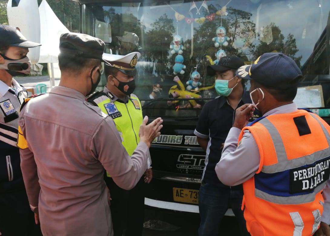 ANTISIPASI: Petugas gabungan meminta salah satu kendaraan yang melewati Cemara Kandang, wilayah perbatasan Provinsi Jawa Tengah dan Jawa Timur untuk putar balik. (ISTIMEWA/LINGKAR)