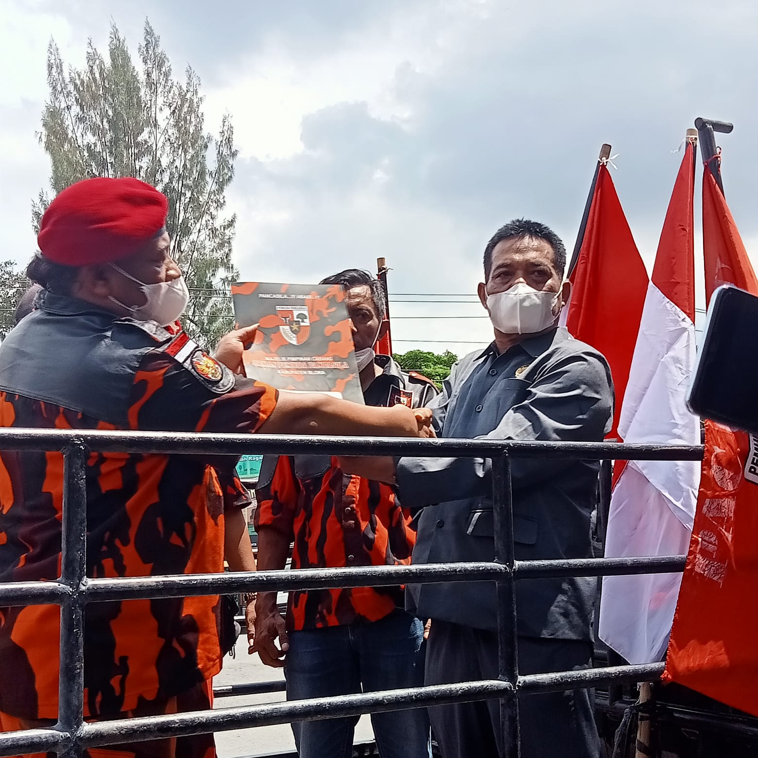 Nampak: munaji dan ketua komisi A DPRD Supardi berdiri diatas mobil komando sembari melihatkan berkas