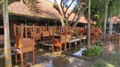 Meja dan kursi sekolah dikeluarkan dari ruang kelas yang sedang dibersihkan. Foto: istimewa
